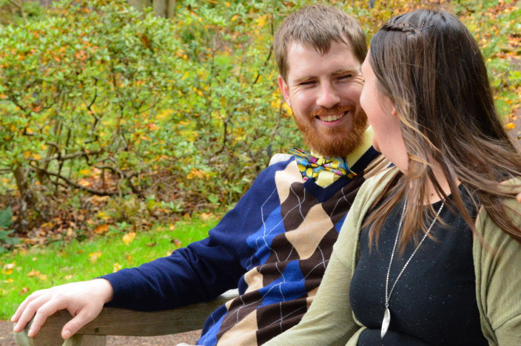 Cute smiles shared in the cute fall woods during their engagement session