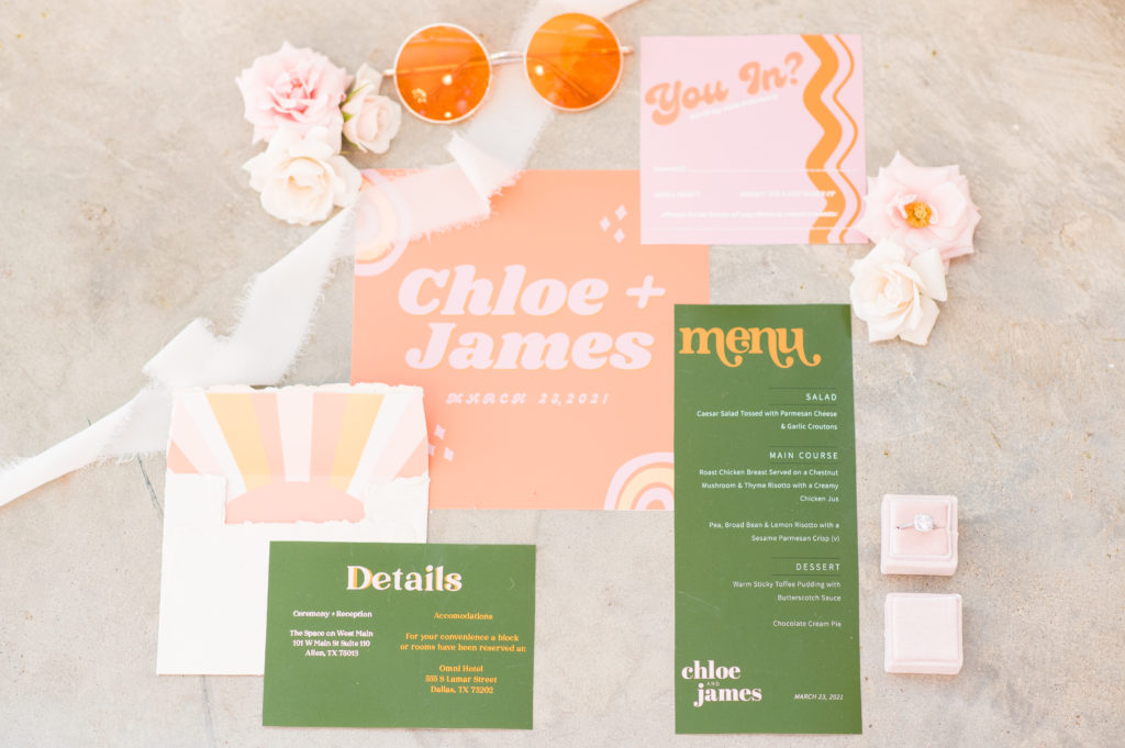 Retro wedding invitations paired with retro glasses and a pink ring box
