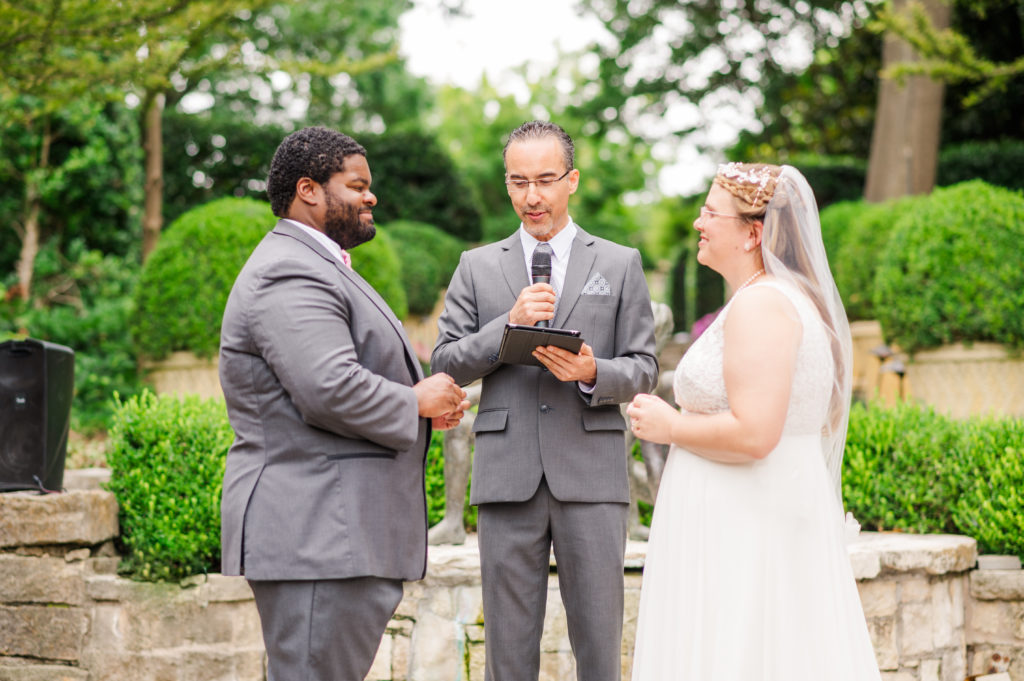 Bride and Groom hold their wedding with their officiant in the Sunken Garden at the Dallas Arboretum and Botanical Gardens in Dallas, Texas. Shot by Danni Lea Photography. Dallas Arboretum wedding 