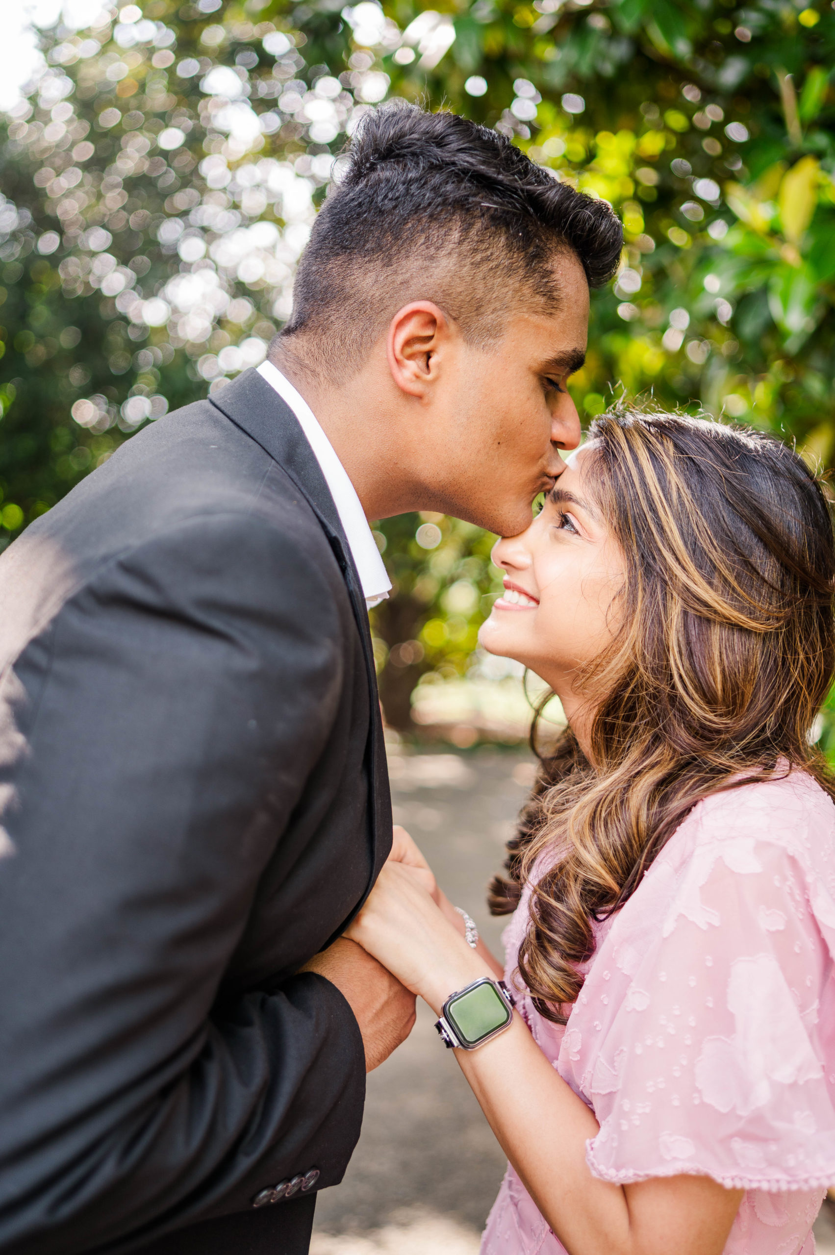 Groom kisses bride on forehead after proposing at the Dallas Arboretum & Botanical Gardens