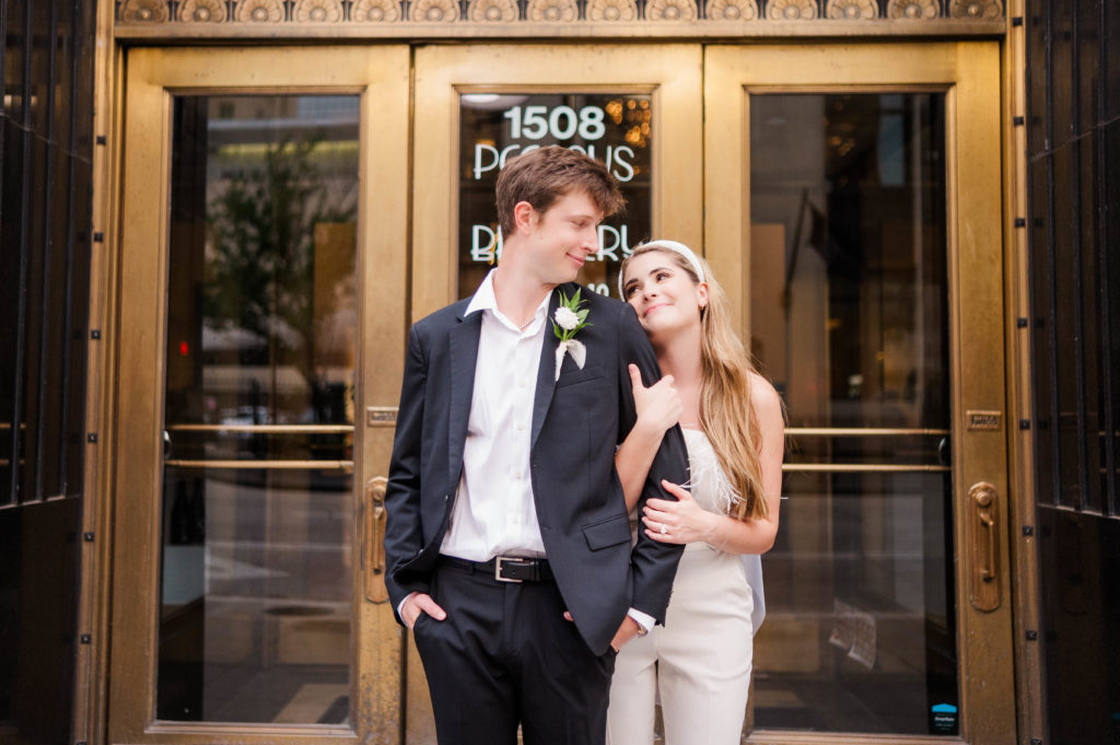 Bride and groom stand outside Pegasus City Brewery as part of their Downtown Dallas Wedding session.