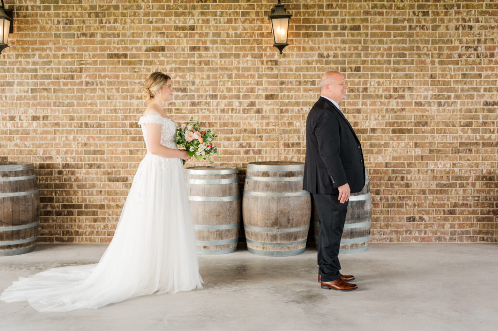 Bride stands behind her dad for their first look at their Texas Vineyard Wedding