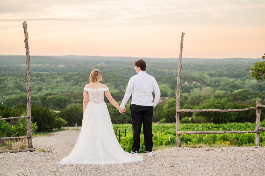 Bride and groom overlook a Texas vineyard wedding venue Dove Ridge vineyard